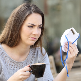 An image of AHP member looking at face mask