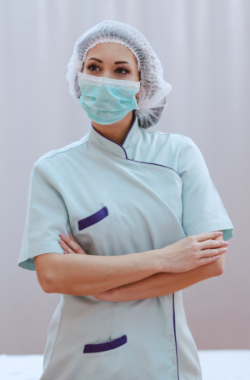 An image of a masked woman hairstylist