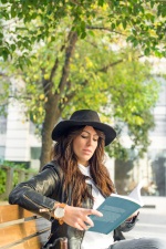 girl reading on park bench