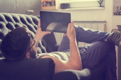 guy on couch with ipad