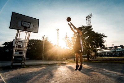 man taking a shot at a basketball hoop