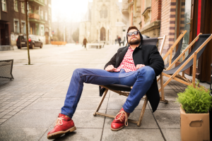 man relaxing on city street