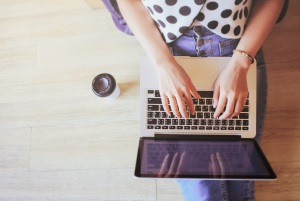 polka dot shirt typing on laptop