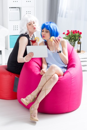 two girls on a pink beanbag chair