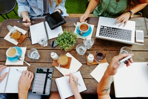 multiple people working around a picnic table