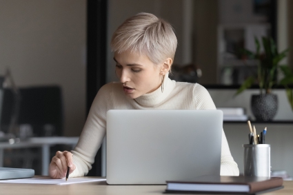 An image of blonde model with pixie hair on laptop for AHP blog