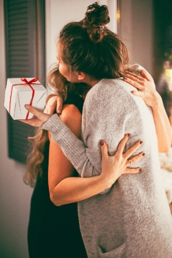 An image of AHP members hugging after exchanging gifts