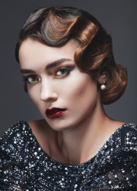 A model poses with the perfect 1920's marcel waves hairstyle.