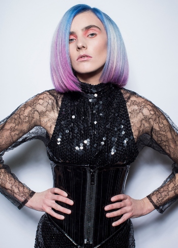 A stock image of rainbow hair and model looking at camera