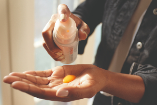 A stock image of man putting hair product in hand