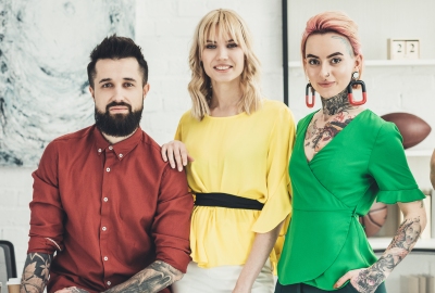 A stock image of three hair stylists looking at camera