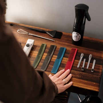A professional barber organizes their tools before seeing a client.