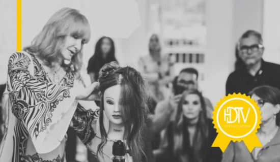 Black and white photo of Vivienne Mackinder teaching a class for hair stylists using a mannequin