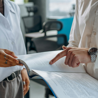 Two professionals reviewing documents