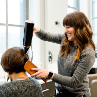 An image of AHP member blowdrying a clients hair