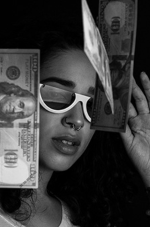 An black and white image of AHP member in white sunglasses with cash