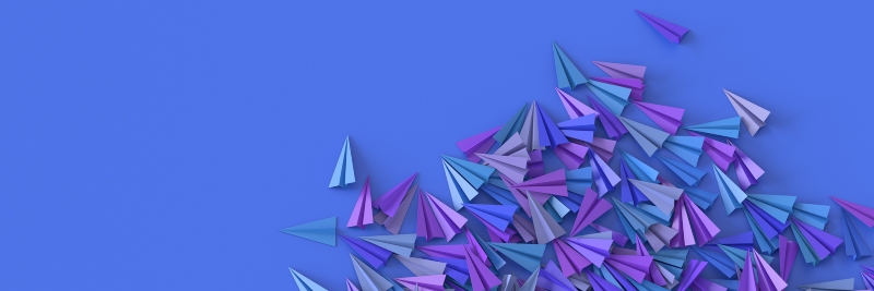 A stock image of blue and purple paper airplanes
