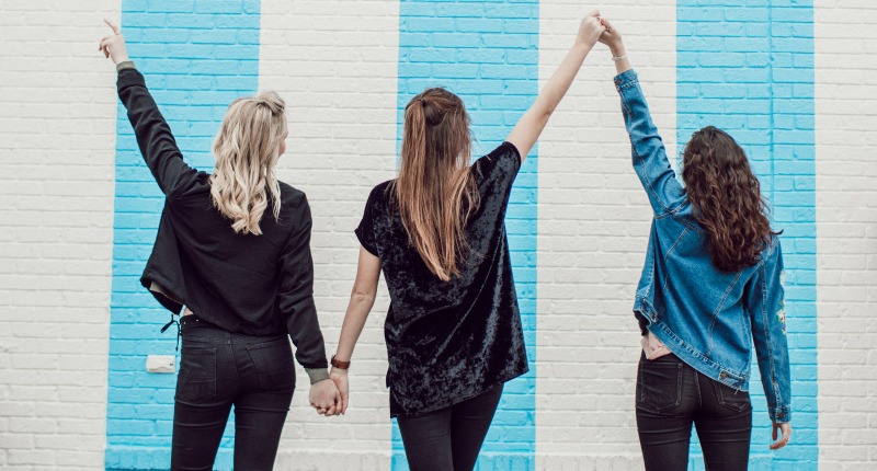 An image of three women holding hands