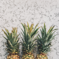 An image of three pineapples laying down