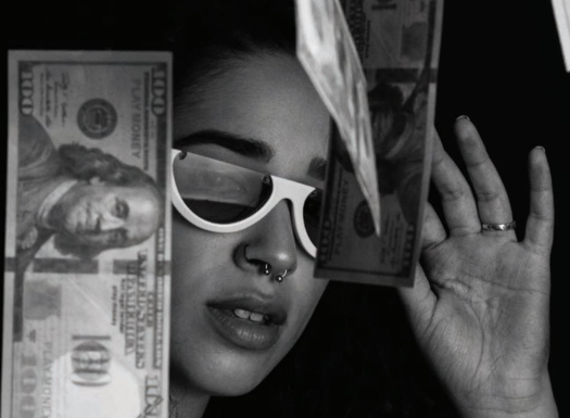 A black and white image of woman with 100 dollar bills