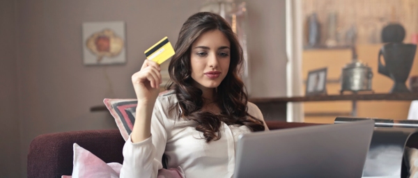 An image of ahp member holding credit card on laptop