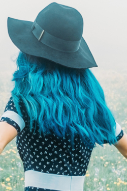 An image of AHP member with teal hair and teal hat