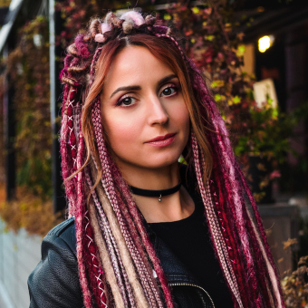 An image of AHP hairstylist with pink dreadlocks