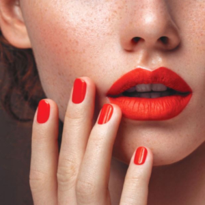 A stock image of model's mouth and hand red nails and lips