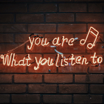 A stock image of neon sign that says you are what you listen to