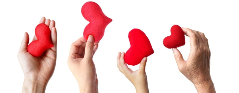 A stock image of hands holding hearts