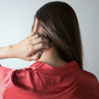 A stock image of woman itching neck