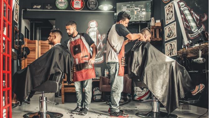 A stock image of two barbers performing services