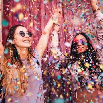 young women celebrating with confetti