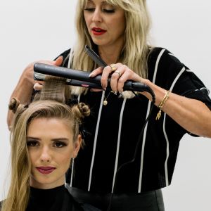 Hairdresser Anna Peters preps her client's roots and mid-shaft with a texturizing iron for a faux shag look.