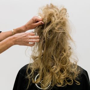 Hair stylist Anna Peters separates her client's curls for a faux shag look.