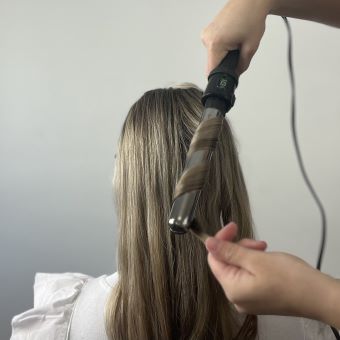 Bride getting her hair curled.