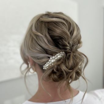 Woman with her hair in a bridal bun.