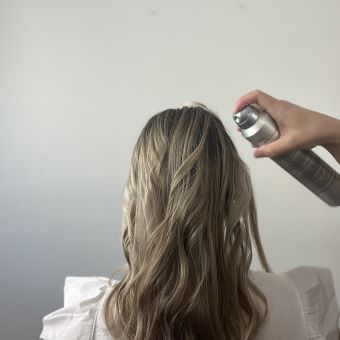 Hairspray being applied to a client