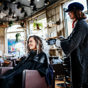 woman applying balayage to client