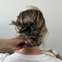Adding two twists to over direct each section and create a bun, secured with pins.