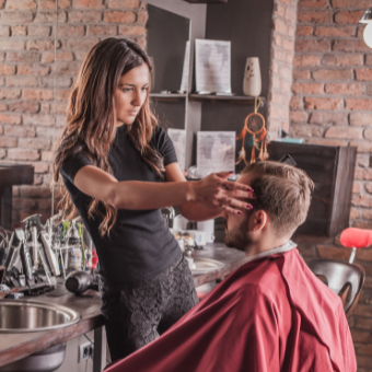 Hairdresser cutting clients hair