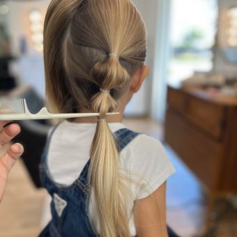 bubble braids being put into girl's hair.