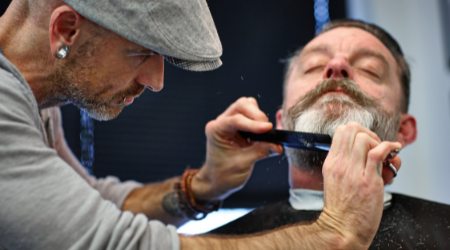 Barber trims clients beard