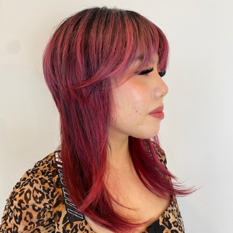 The profile view of a model featuring her octopus bangs and layering.