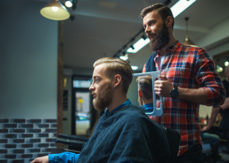 Barber clipping client's hair