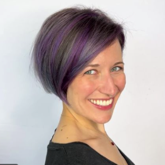 A client smiles as she shows off her disconnected french bob haircut. 