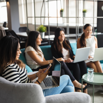 group of women with laptops