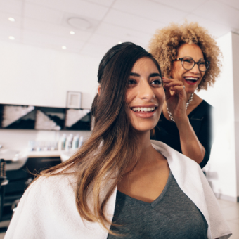 Hairdresser working with client