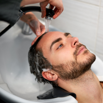 Male client gets his hair shampooed