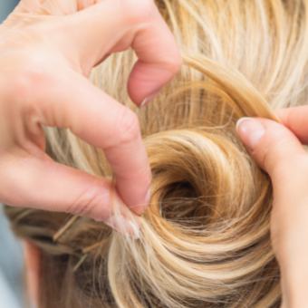 stylist pinning a bun